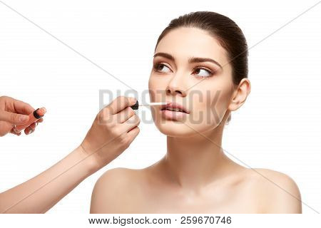Girl Applying Pink Lipstick Isolated On White