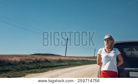 Beautiful Independent Woman Enjoys Road Adventure. Successful Woman Freedom Holidays Concept. Vacati