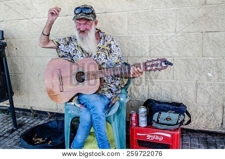 Torrevieja, Spain - Sept. 23 2018 :  Merlin Busking With Guitar Outside Carrefour Store