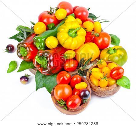 Assorted tomatoes and vegetables isolated on white background. Photo for your design.