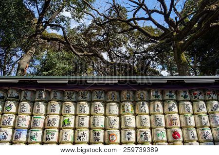 Tokyo, Japan - 12 Feb 2018: Sake Rice Barrels Piled Up With Green And Red Inscriptions In Yoyogi Par