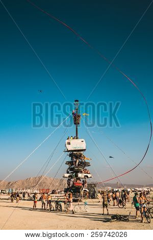Guatemala - July 30, 2018. People Climbing Up The Huge Art Car Installation In The Middle Of A Deser