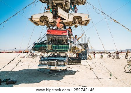 Guatemala - July 30, 2018. People Climbing Up The Huge Art Car Installation In The Middle Of A Deser