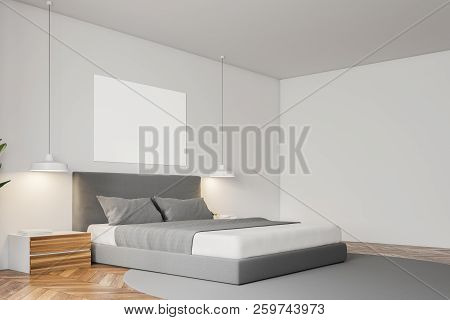 Corner Of White Wall Minimalistic Bedroom With A Wooden Floor, A Grey Carpet With Masterbed Standing