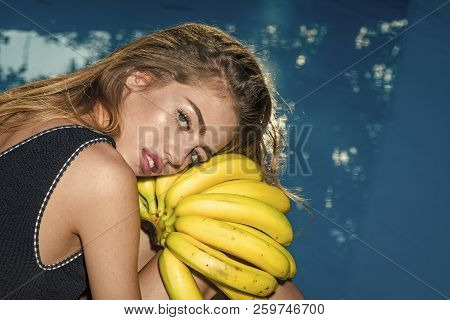 Sexy Woman With Tropical Fruit In Pool. Dieting And Healthy Organic Food, Vegetarian. Woman Relax In