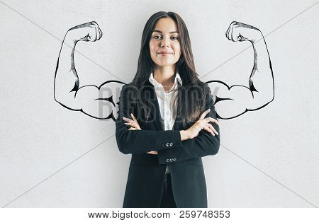 Portrait Of Attractive Young European Businesswoman With Drawn Muscly Arms. Confidence And Strength 