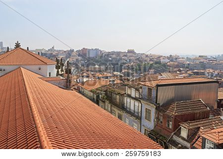 Scenic View Of Porto, Portugal From The Window Of The Tower. Orange Roofs Of The Houses. Popular Tou