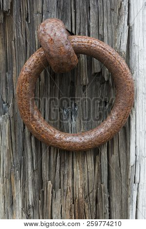Rusting Metal Ring Attached To An Old Sleeper With A Thick Metal Pin. Found At The Site Of A Disused