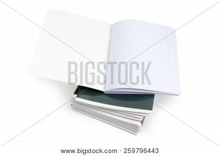 Open Blank Exercise Book With Pages Of Squared Paper And Red Vertical Lines For A Margins On A Stack