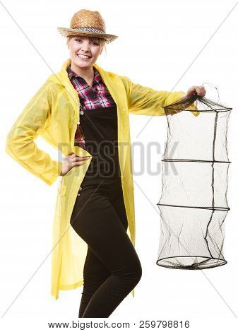 Spinning, Angling, Cheerful Fisherwoman Concept. Happy Woman In Yellow Raincoat Holding Empty Fishin