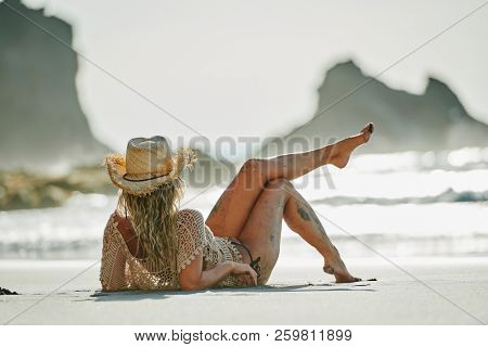 young woman relaxing on the beach in summer day