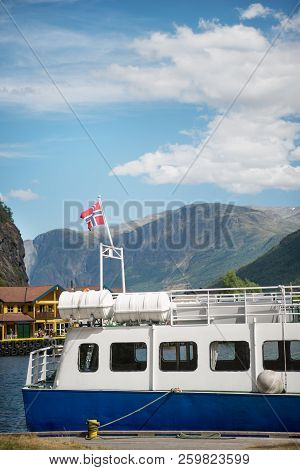Aurlandsfjord, Flam, Norway - 27 July, 2018: Boat With Norway Flag Moored In Harbour At Aurlandsfjor