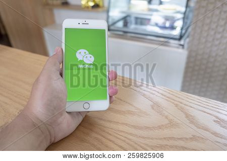 Chiang Mai / Thailand - September 22 2018 :a Man Sit In Cafe Holding Mobile With Wechat Screen