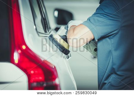 Professional Vehicle Buffing By Caucasian Car Detailing Service Worker. Removing Scratches From The 