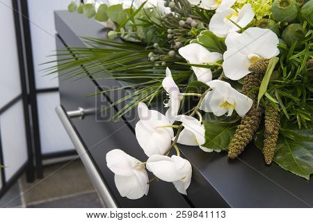 A Flower Arrangement On A Coffin In A Mortuary