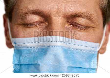 Close Up Doctor In Mask Closed Eyes. Macro Close Up Of Human Eyes. Doctor Is Meditating Before Opera