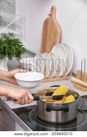 Woman Preparing Corn In Stewpot On Stove, Closeup