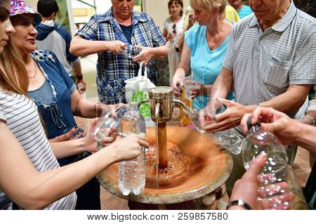 Sochi, Russia - June 1. 2018. People Gain Mineral Water From Narzan Source Chvizhepse