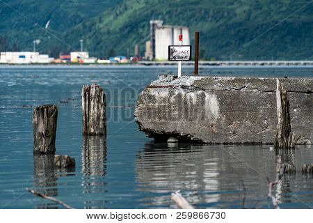 August 10 2018 - Valdez, Ak: Historical Marker Shows The Ruins Of The Village Morgue In Old Town Val
