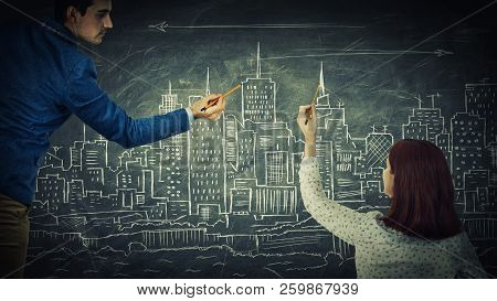 Man And Woman Sharing Thoughts Together Drawing A City On A Blackboard. Urbanistic Planning, People 