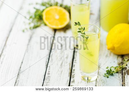 Traditional Italian Lemon Liqueur Limoncello And Fresh Citrus Lemon. Alcoholic Beverage.