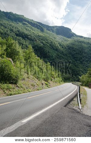 Empty Asphalt Road And Beautiful Mountains Covered With Green Vegetation, Aurlandsfjord, Flam Aurlan