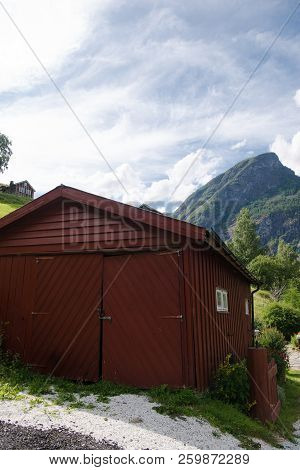 Brown Wooden Barn And Beautiful Mountains Behind, Aurlandsfjord, Flam Aurlandsfjorden , Norway