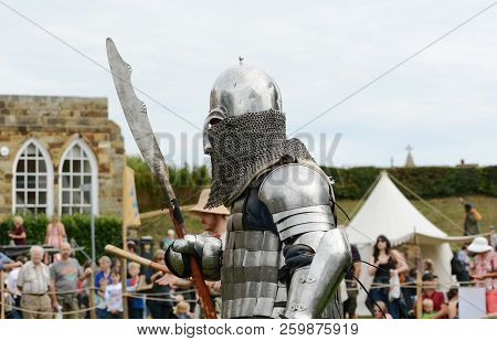 Medieval Knight In Battle Armour, Carrying A Pole Arm