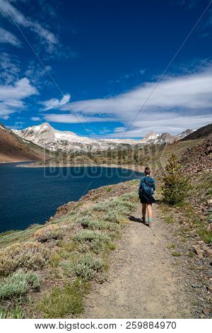 Female Hiker Walks Along The Saddlebag Lake Trail In California, In The Eastern Sierra Nevada Mounta