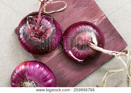 Crimean Sweet Onion On A Old Wooden Board. Three Whole Large Round Onions On Table.fresh Red Onions 