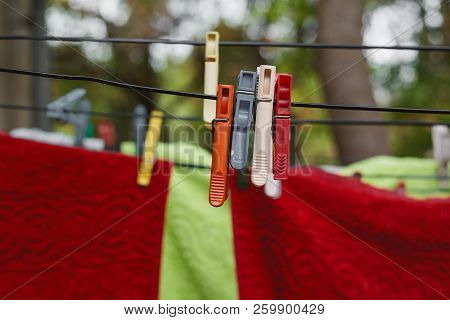 Plastic Colorful Clothespins And Laundry On Clothesline