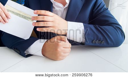 Closeup Image Of Corrupted Official Receiving Bribe In Envelope At Office
