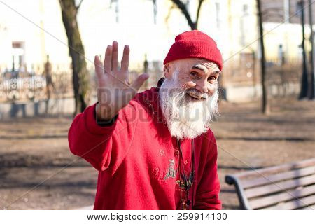 April 15, 2017. Moscow Russia. Moscow Streets. Portrait Of An Elderly Man Smiling And Waving His Han