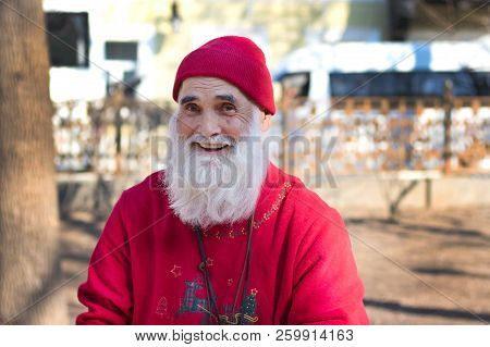April 15, 2017. Moscow Russia. Moscow Streets. Portrait Of An Elderly Man Smiling In A Red Hat And A