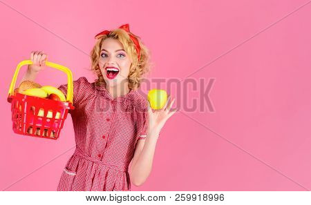 Woman Shopping At Supermarket. Pinup Girl With Shopping Basket&apple. Smile Lady Holds Grocery Baske