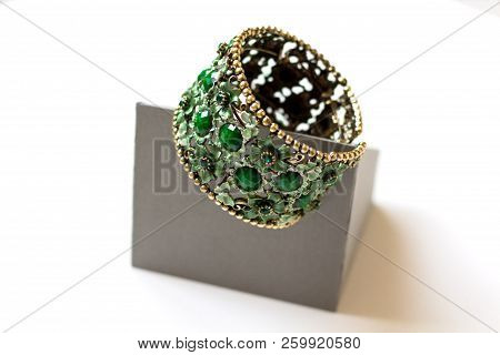 Exquisite Jade Bracelet With Metal Weave On A Light Background. Close-up. Top View