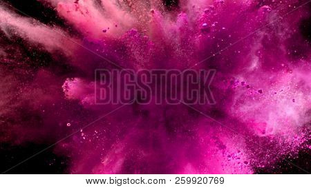 Explosion of coloured powder isolated on black background. Abstract colored background