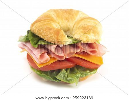 Ham And Cheese Sandwhich With Lettuce Cheese And Tomatoes On A Fresh Croissant