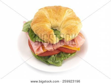 Ham And Cheese Sandwhich With Lettuce Cheese And Tomatoes On A Fresh Croissant