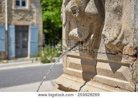 Stream Of Water Coming Out Of A Roman Art Fountain