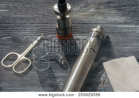 Still Life With E-ciggarete And Coffe On The Wooden Background