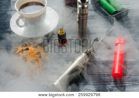 Still Life With E-ciggarete And Coffe On The Wooden Background