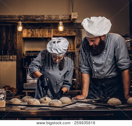Cooking Master Class In Bakery. Chef With His Assistant Showing Ready Samples Of Baking Test In Kitc