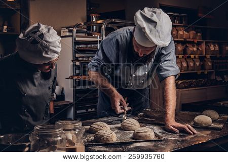 Cooking Master Class In Bakery. Chef With His Assistant Showing Ready Samples Of Baking Test In Kitc