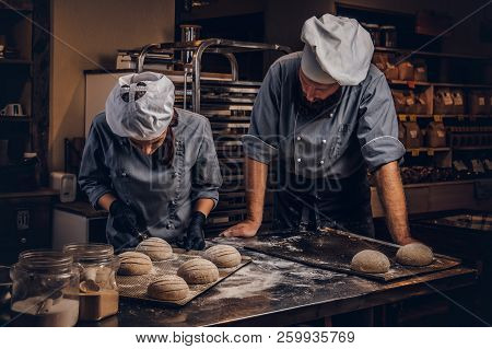 Cooking Master Class In Bakery. Chef With His Assistant Showing Ready Samples Of Baking Test In Kitc