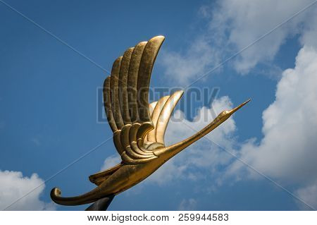 Singapore, Singapore - August 23, 2013: Statue Of Golden Bird Against Blue Sky On The Background. Pa