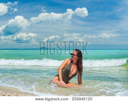 woman sunbathing on the beach summer travel holidays