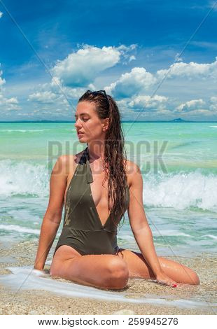 woman sunbathing on the beach summer travel holidays