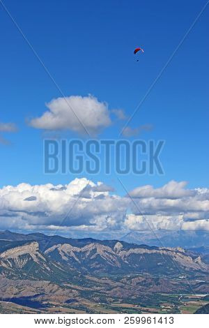 Paraglider Flying In The French Alps From The Chabre Mountain