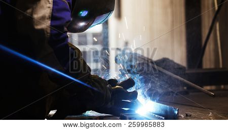 Worker Cutting Metalsheet By Acetylene Torch With Bright Sparks